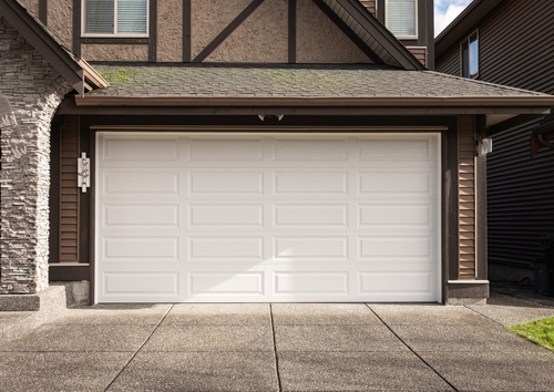 A sleek white garage door, characteristic of Miami homes, emphasizing a contemporary aesthetic.