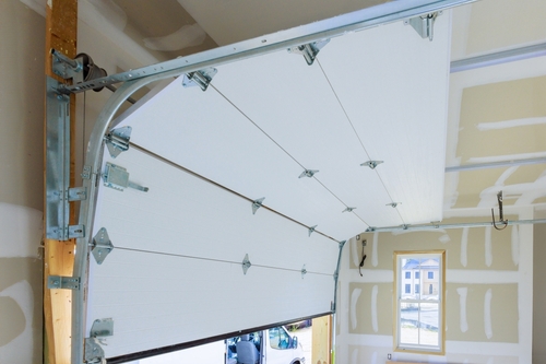 A white garage door with a matching frame, illustrating garage door repair options available in Miami.