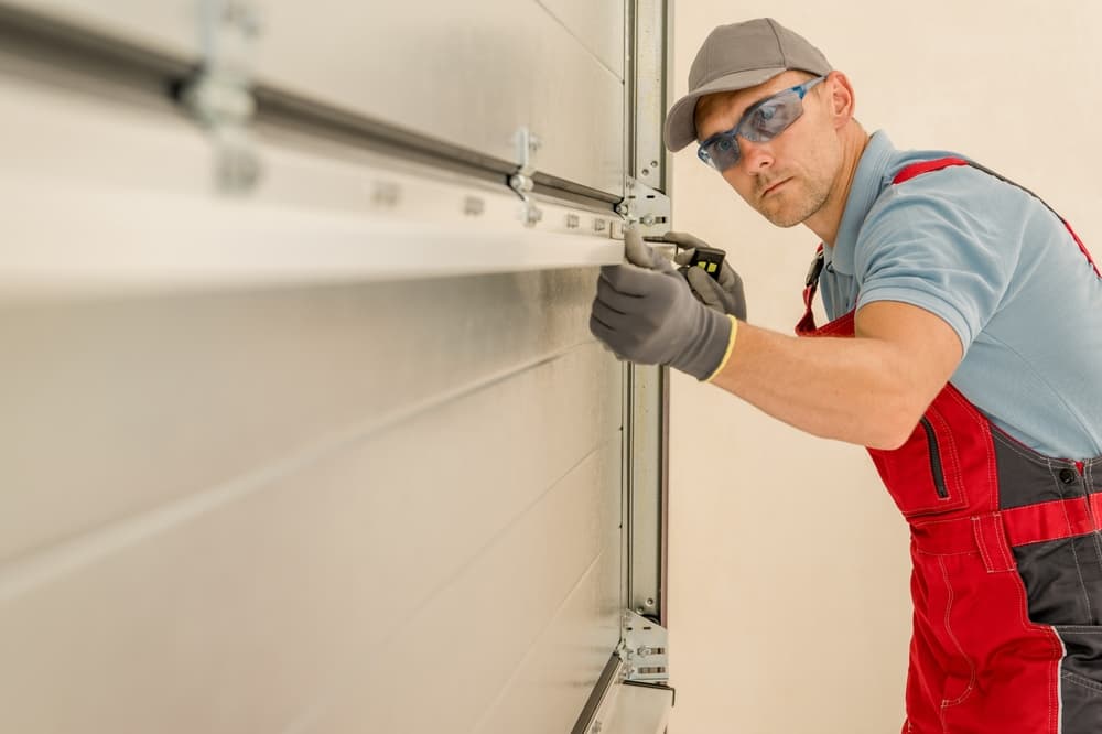 man-installing-garage-door