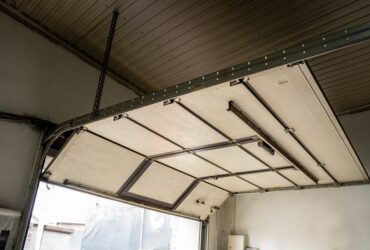 Open sectional garage door with metal tracks
